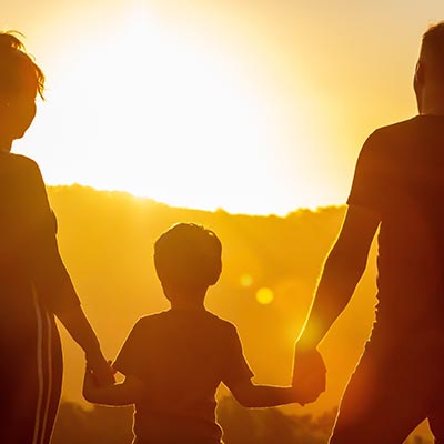 Family Holding Hands Sunset